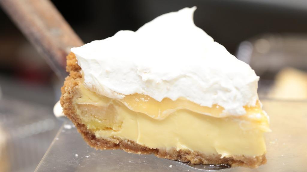 Key Lime Pie · A slice of Key lime filled, whipped cream topping, and graham cracker crust.