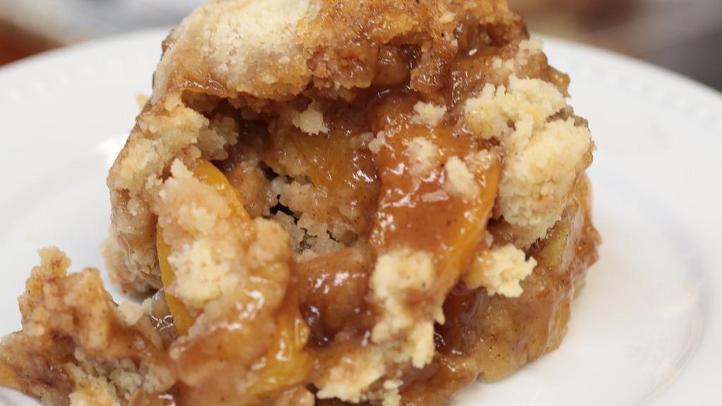 Peach Cobbler · A thick crusted cobbler, filled with perfectly spiced peaches served in an 8 oz bowl.