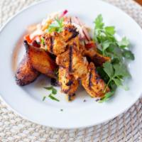 Grilled Chicken Skewers (Catering) · All natural marinated chicken breast, served with roasted sweet plantains and cilantro lime ...