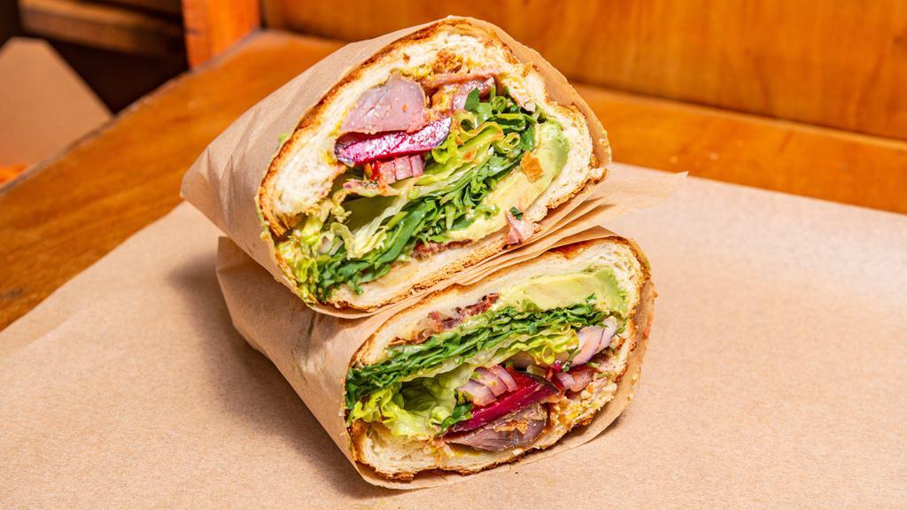 Turkey, Bacon, Avocado · With the werks (lettuce, arugula, seasonal fruit compote, spicy mustard, red onion, roma tomato, purple pickle, cilantro, roast garlic, and roast red bell pepper sauces, fresh lemon, sesame salt, and pepper).