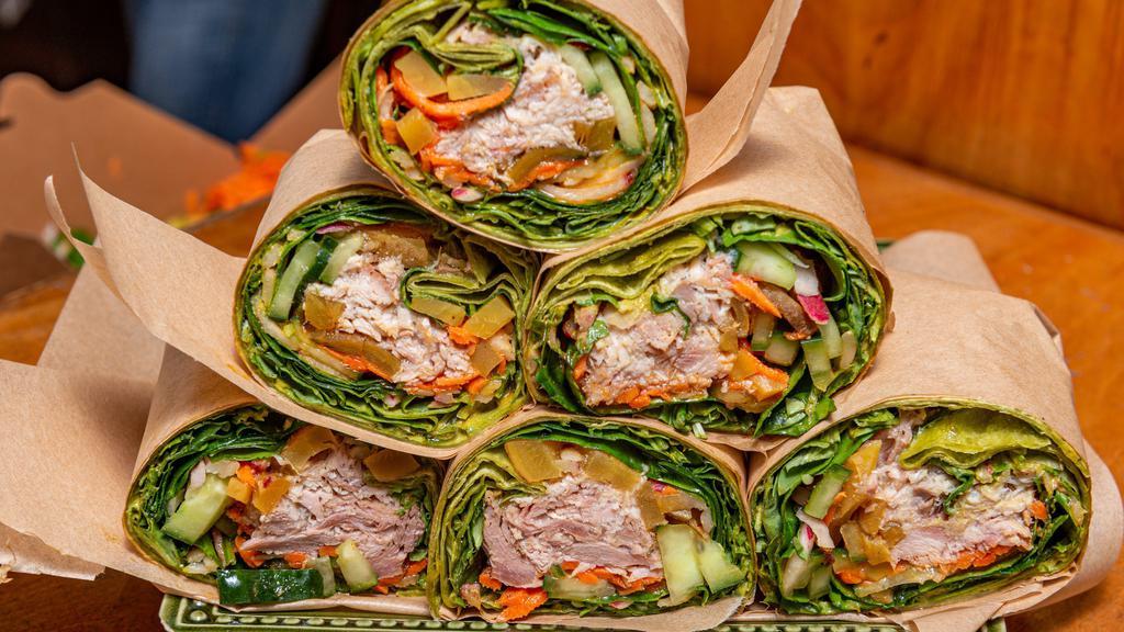 Surfin' Bird Wrap · Turkey, almond pesto, and the twerks (spinach, arugula, cucumber, carrots, radish, beets, green sprouts and bean sprouts, toasted sesame salt, fresh lemon, pepper, roast garlic and roast red bell pepper sauces) in a spinach tortilla.