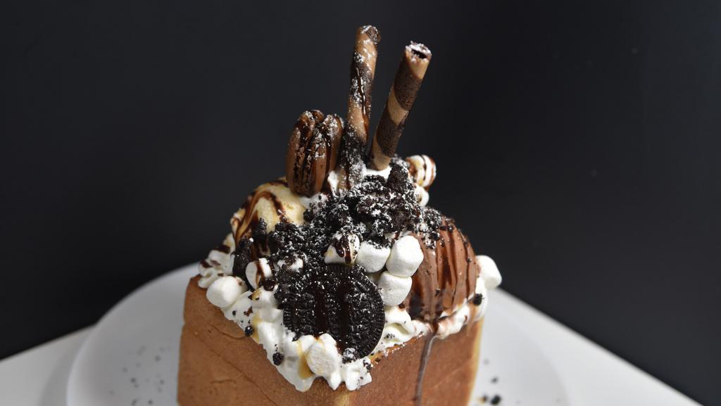 Oreo Explosion Bread House · Our Oreo Explosion Bread House comes with one scoop chocolate ice cream, one scoop vanilla ice cream. Oreo, marshmallow topping. Chocolate and caramel syrup.