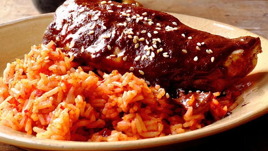 Chicken Mole · Rice, refried beans and green salad.