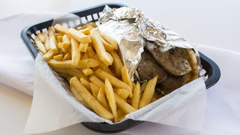 Gyro · Beef gyro strips topped with tomatoes, onions, lettuce and tzatziki sauce wrapped in pita bread served with French fries.