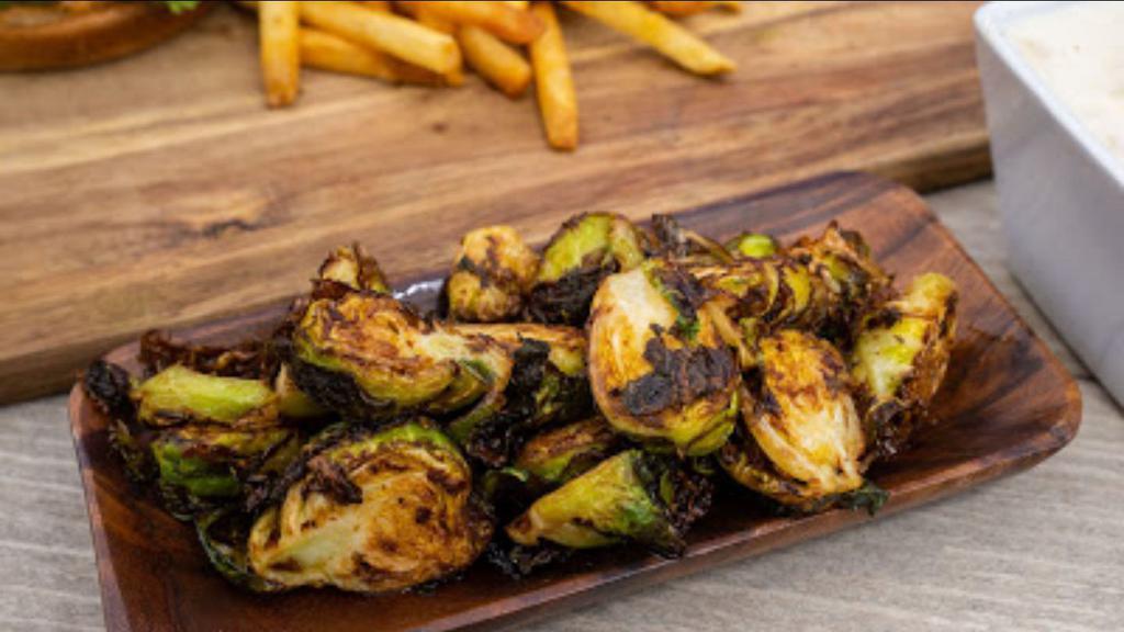 Brussels Sprouts · Crispy fried Brussels sprouts with capers & house made preserved lemon dressing.
