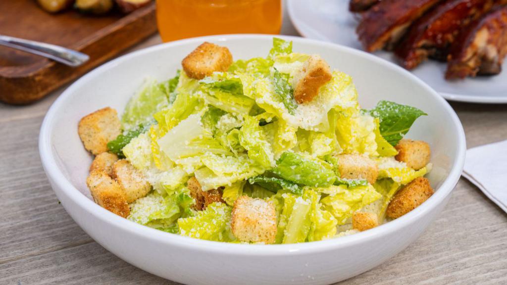 Side Caesar Salad · Croutons, parmesan cheese, classic Caesar dressing.
