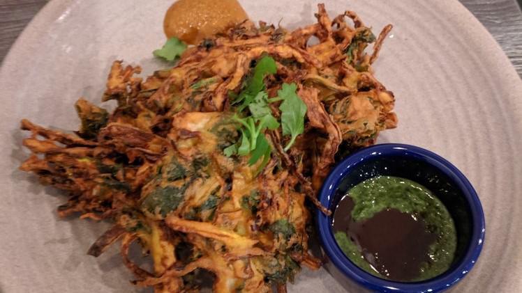 Vegetable Pakora · vegan. gluten-free. Fritters made with seasonal vegetables, served with both mint pesto and tamarind sauce.