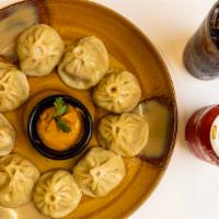 Chicken Momo · Dumplings made with in-house ground chicken served with a tomato sauce.