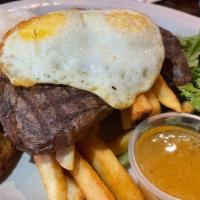 Bistec a lo Pobre · Gluten-free. Grilled ribeye steak (USDA), fried egg, French fries & fried plantains, served ...