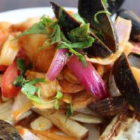 Saltado de Mariscos · Gluten-free, dairy-free. Seafood stir-fry, red onions, tomatoes, served with rice & French f...