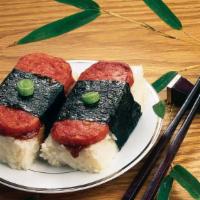 Spam Musubi · Grilled spam placed atop a block of steamed white rice and musubi sauce, all wrapped in seaw...