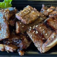 Kalbi (BBQ Beef Short Ribs) · BBQ beef short ribs, comes with steamed rice and side dishes.