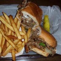 Philly Cheesesteak · Sliced Sirloin, White American Cheese, Grilled Onions and Bell Peppers  on a French Roll. Se...