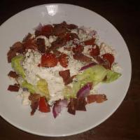 Wedge Salad · Iceberg Wedge, Bacon, Red Onion, Blue Cheese Crumbles and Grape Tomato served with Bleu Chee...