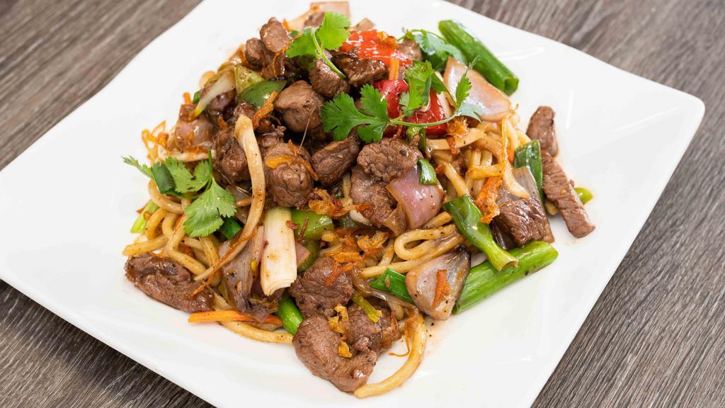 15. Shaking cube Beef over garlic fried rice or chow mein · shaking cube steak stir fried with garlic over rice or chow mein