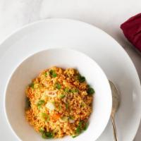 Kus Kus · Steamed couscous simmered in vegetable broth with green peas,  garbanzo beans and carrots an...