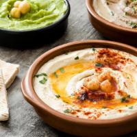 Hummus · Chickpeas blended with tahini, olive oil, lemon and spices (served with warm pita bread).