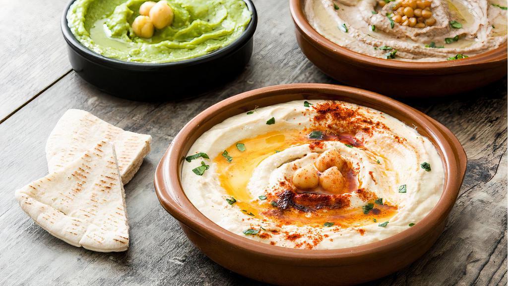 Hummus · Chickpeas blended with tahini, olive oil, lemon and spices (served with warm pita bread).