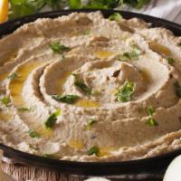 Baba Ganoush · Roasted eggplant blended with tahini, olive oil, lemon and spices (served with warm pita bre...