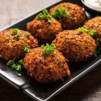 Falafel Balls · Ground chickpeas, onion, garlic and tahini formed into balls and deep fried.