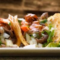 Tacos · Choice of meat, onions, cilantro, hot or mild salsa.