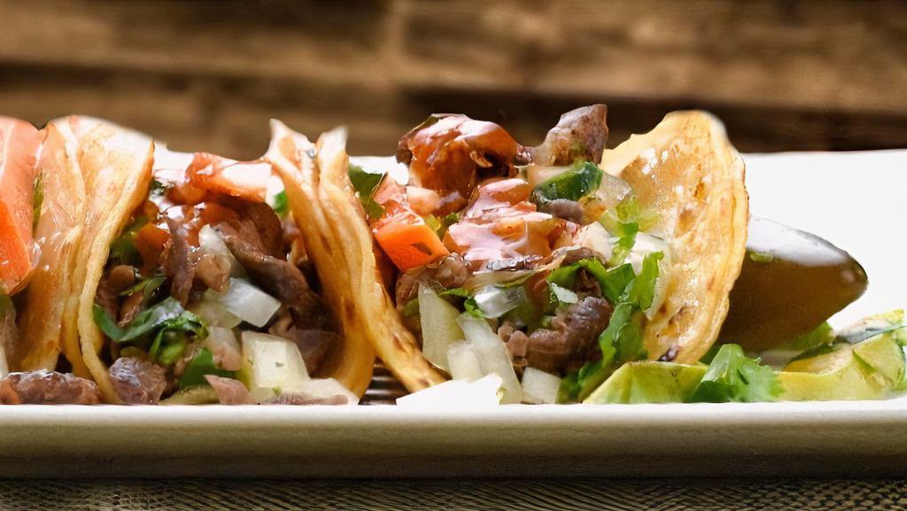 Tacos · Choice of meat, onions, cilantro, hot or mild salsa.