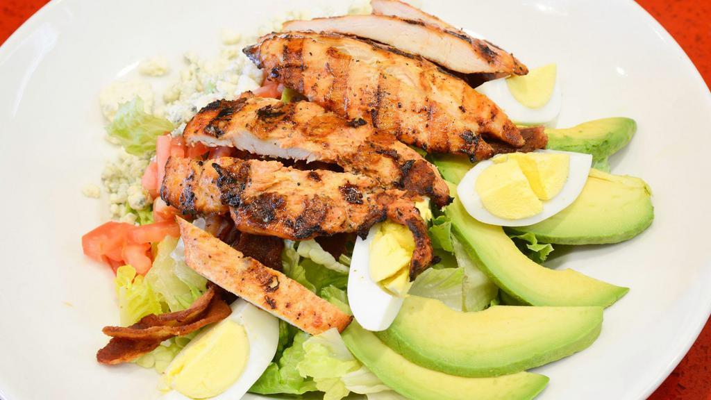 Cobb Salad · Crisp romaine, grilled chicken breast, applewood smoked bacon, avocado, hard boiled eggs, crumbled bleu cheese, chopped tomato, and choice of peppercorn ranch or balsamic vinaigrette dressing.