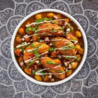 Aloo Tikki Chaat · Potato croquette served on the bed of garbanzo beans.