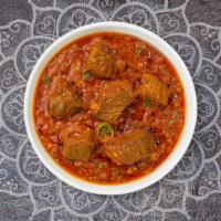 Lamb Curry · Juicy lamb cooked in a tomato based onion gravy with freshly ground spices.
