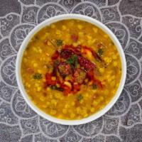 Yellow Daal Tadka · Split pea lentil cooked with garlic, tomato, mustards, and curry leaves.