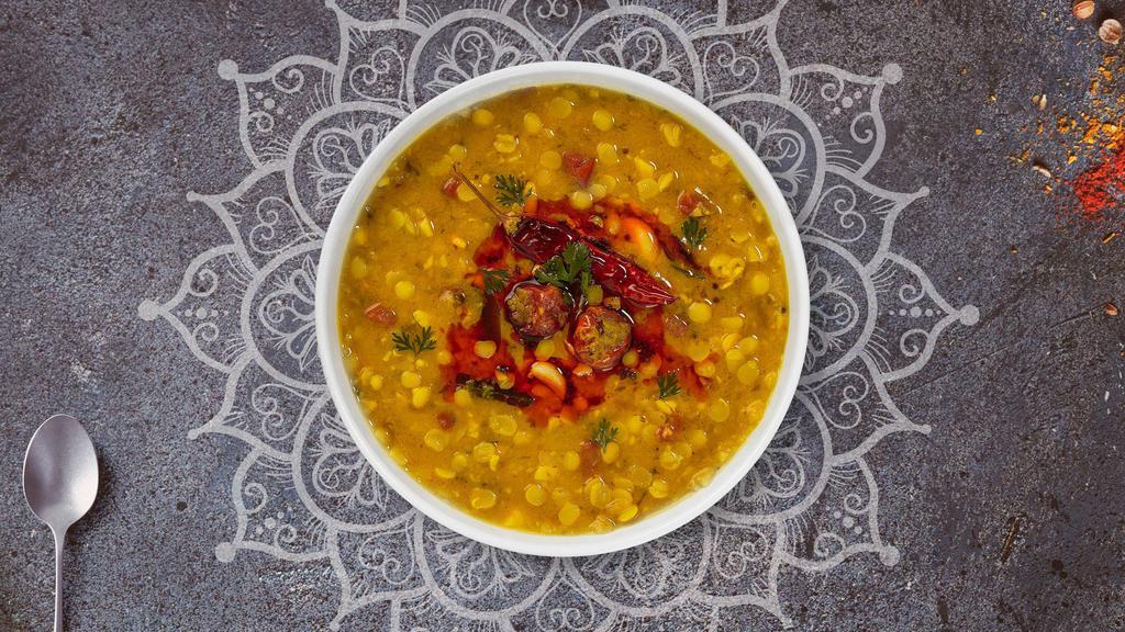 Yellow Daal Tadka · Split pea lentil cooked with garlic, tomato, mustards, and curry leaves.