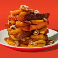 Apple Stuffed Cinnamon French Toast · Two slices of egg-washed french toast stuffed with caramel glazed apples and walnuts and top...