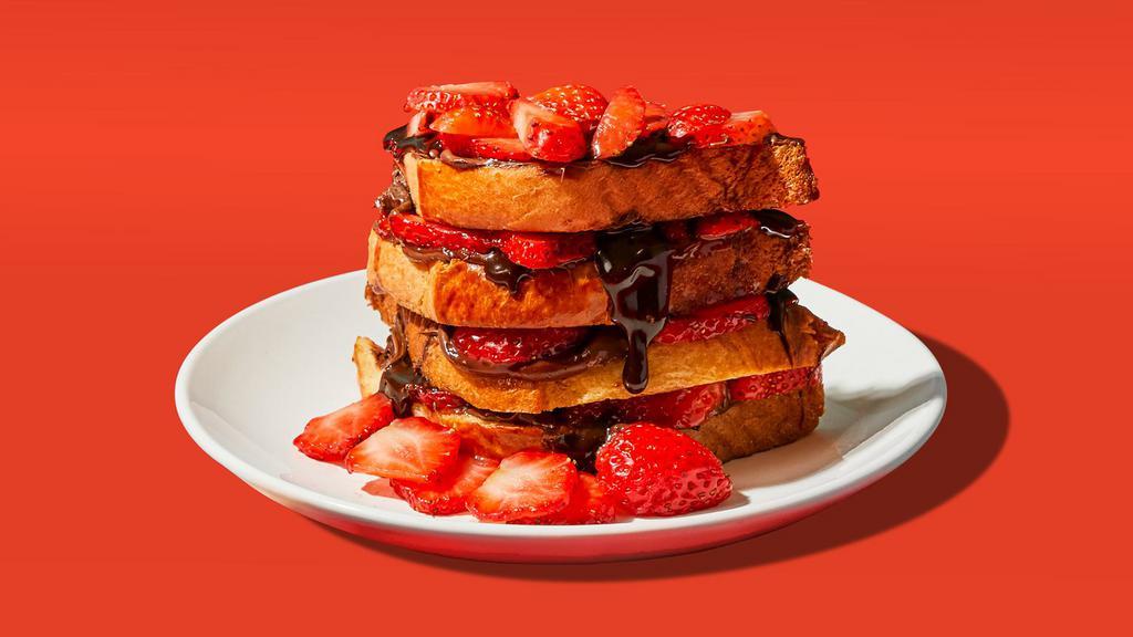 Nutella & Strawberry French Toast · Two slices of egg-washed french toast topped with nutella, strawberries, syrup, and butter.