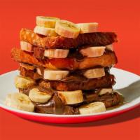 Nutella Banana French Toast · Two slices of egg-washed french toast topped with banana, nutella, syrup and butter.