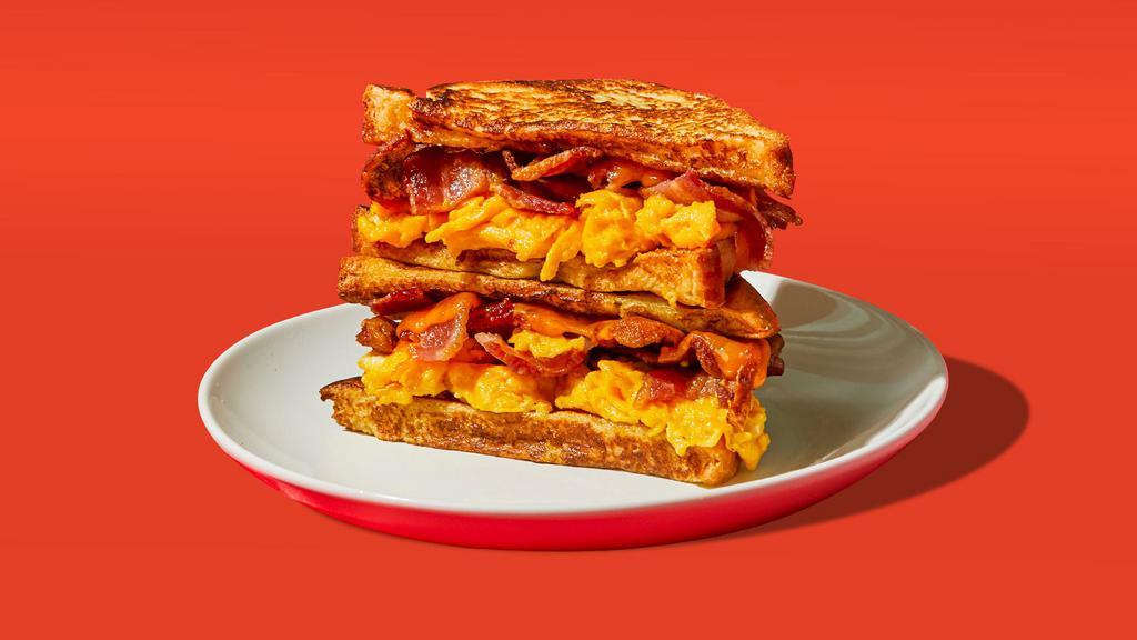Bacon Egg & Cheese French Toast Sandwich · Two eggs, melted cheese, and bacon served between two slices of french toast.