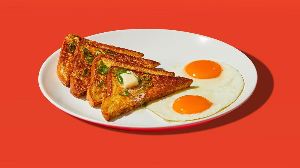 Savory French Toast Plate · Two slices of egg-washed french toast served with two eggs.