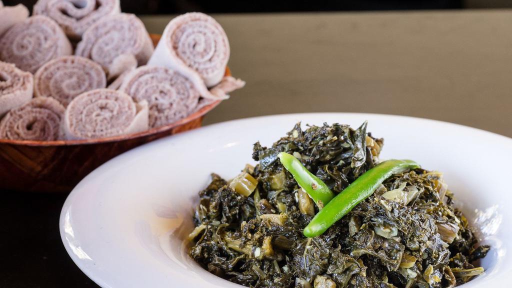 Gomen · Vegan. Fresh seasonal greens steamed cooked with onions, ginger and garlic. Comes with two pieces of injera.