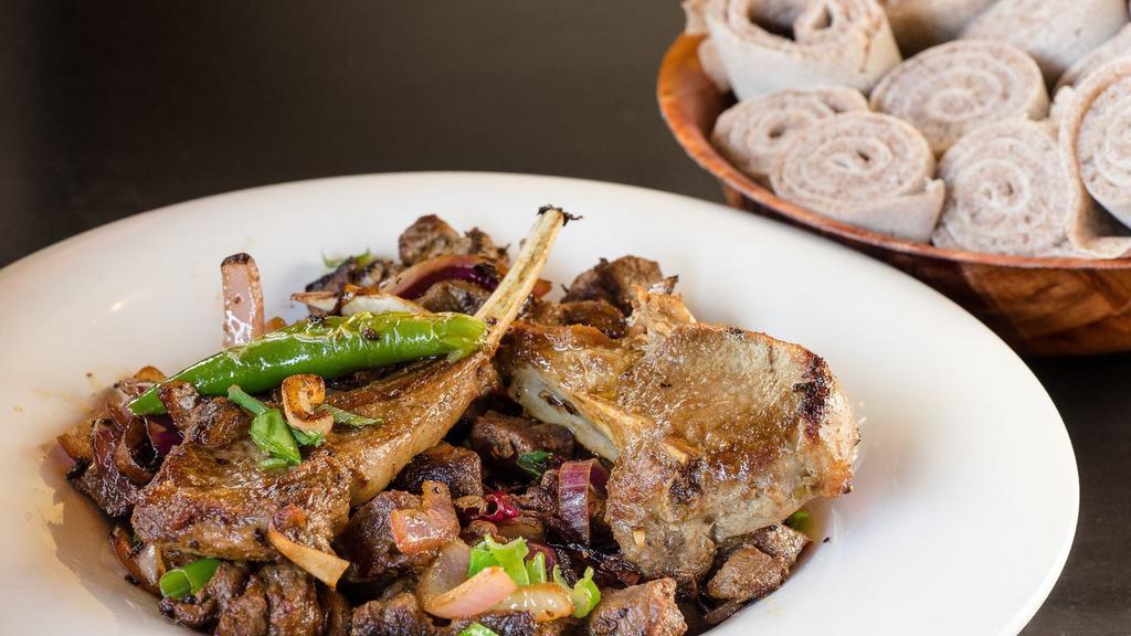 Darek Tibs · Lamb cubes grilled crispy and with two lamb chops, red onion, hot pepper, garlic and organic ethiopian spices and ghee.