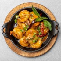 Skillet Shrimp · Shrimps tossed with lime juice, garlic, ginger, dried chili and served with hot plate.