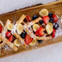Strawberry Fruit Waffle · Strawberry Waflle mix topped with fresh strawberries and sugar powder. Included maple syrup
