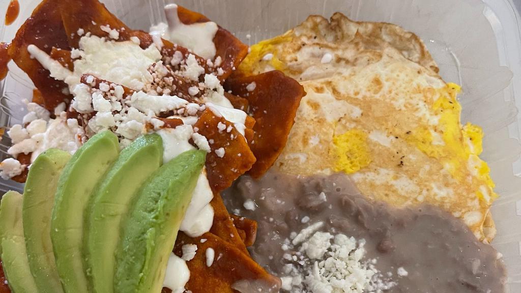 Regular Chilaquiles · Fried Tortillas chips with homemade red sauce, refried beans, 2 eggs, mexican cheese, sourcream  and avocado