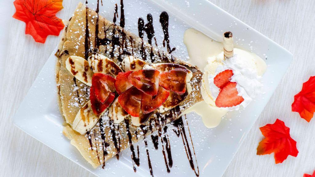Spill the Tea crepe · Banana, strawberries, Nutella, and whip cream.