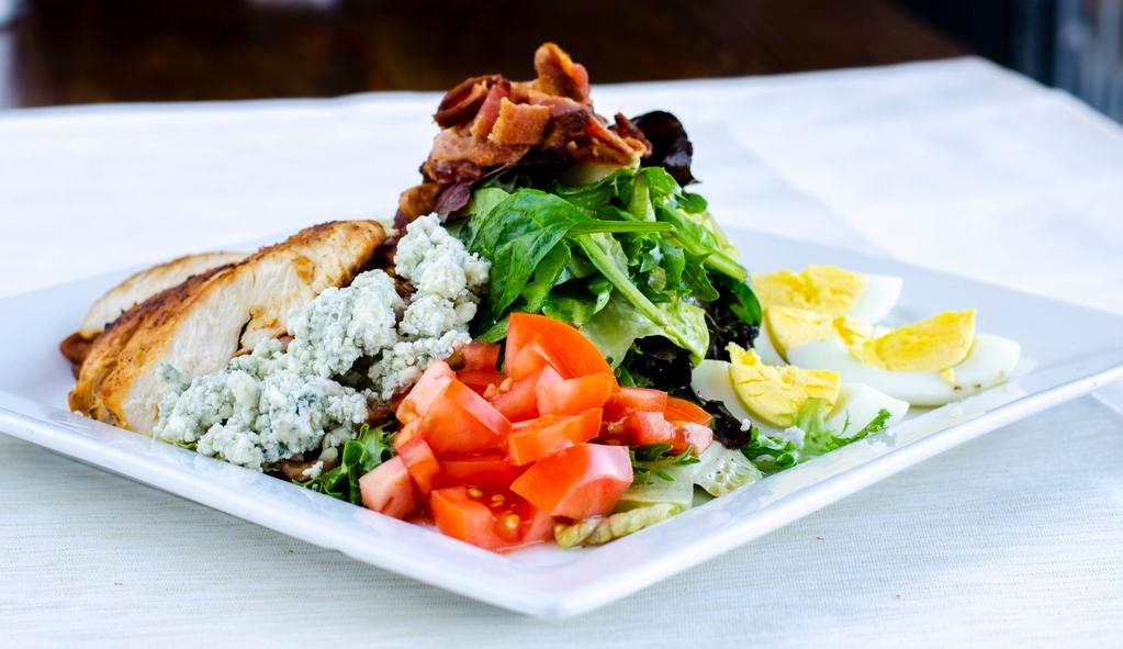 Cobb Salad · Chicken, Spring mix, diced bacon, hard boiled egg, blue cheese, tomato, and avocado and ranch dressing. Included Garlic Bread