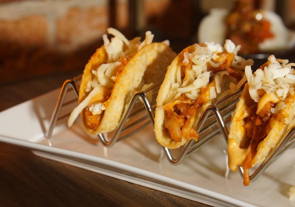Chicken Tacos (3 pcs) · Spicy. White chicken, carrot, cabbage, Mexican and goat cheese, sriracha ranch and crispy shell.