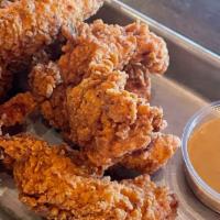 Chicken Tenders · 6 strips of house breaded chicken breast served with a side of honey mustard or bbq sauce