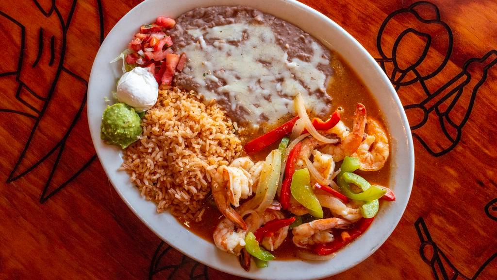 Camarones Rancheros · Shrimp sauteed in butter, garlic, onions, bell peppers and ranchera sauce. Served with rice, beans, guacamole, sour cream and flour or corn.