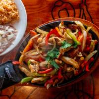 Fajitas · Marinated strips of beef or chicken freshly grilled to order with fresh tomatoes, onions and...