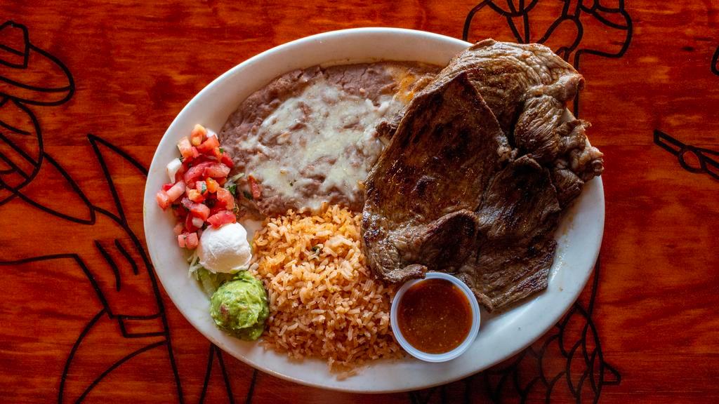 Carne Asada · Charbroiled steak served with rice, beans, guacamole, sour cream and corn or flour tortillas.