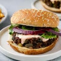 TM Chipotle Black Bean Burger · Brioche bun, black bean patty, lettuce, tomato, pickles, onion.