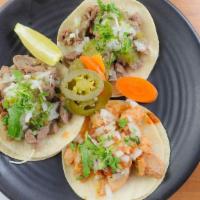 Street Tacos · Three street tacos choice of chicken or beef, salsa verde, cilantro, onion.